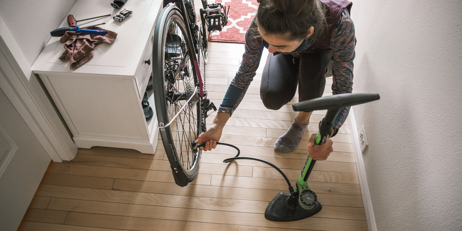 A person adding air to bike tires