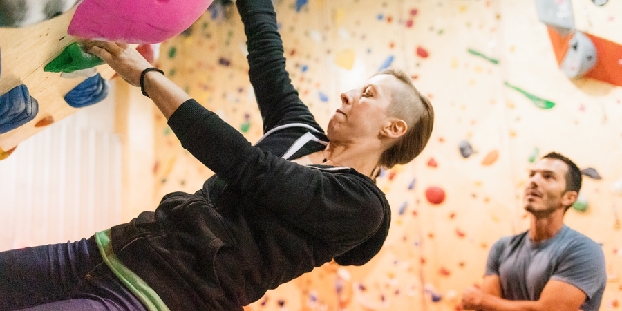 person bouldering indoors