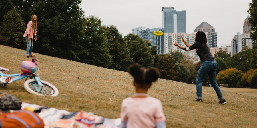 Two people toss a flying disc in a park