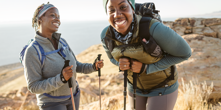 Two hikers using trekking poles