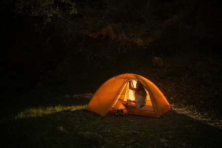 A tent at night illuminated from inside