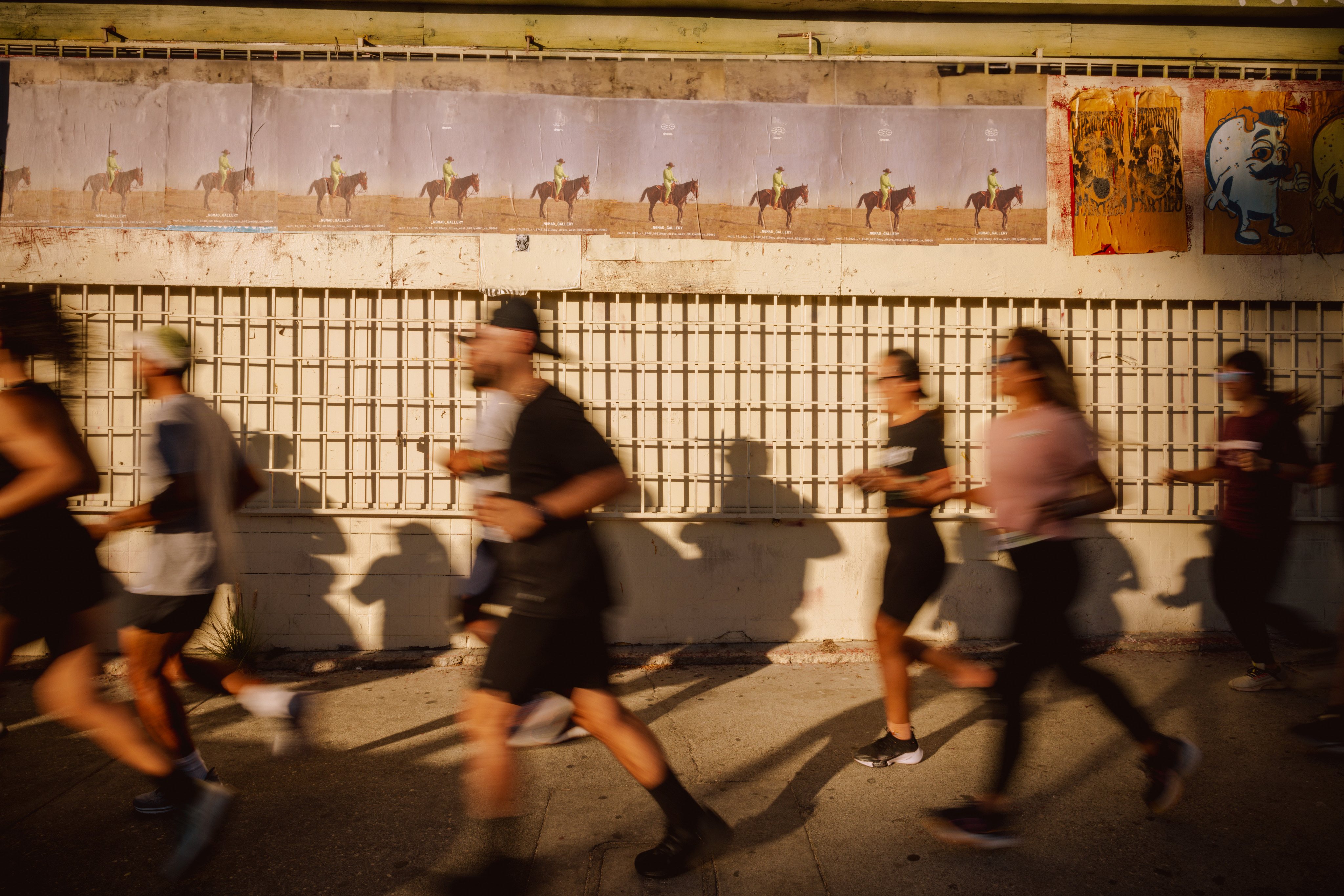 Group of runners jogging in the afternoon sun.