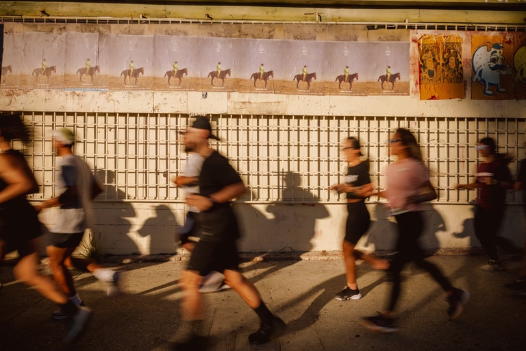 A slightly blurred image of people running in downtown Los Angeles