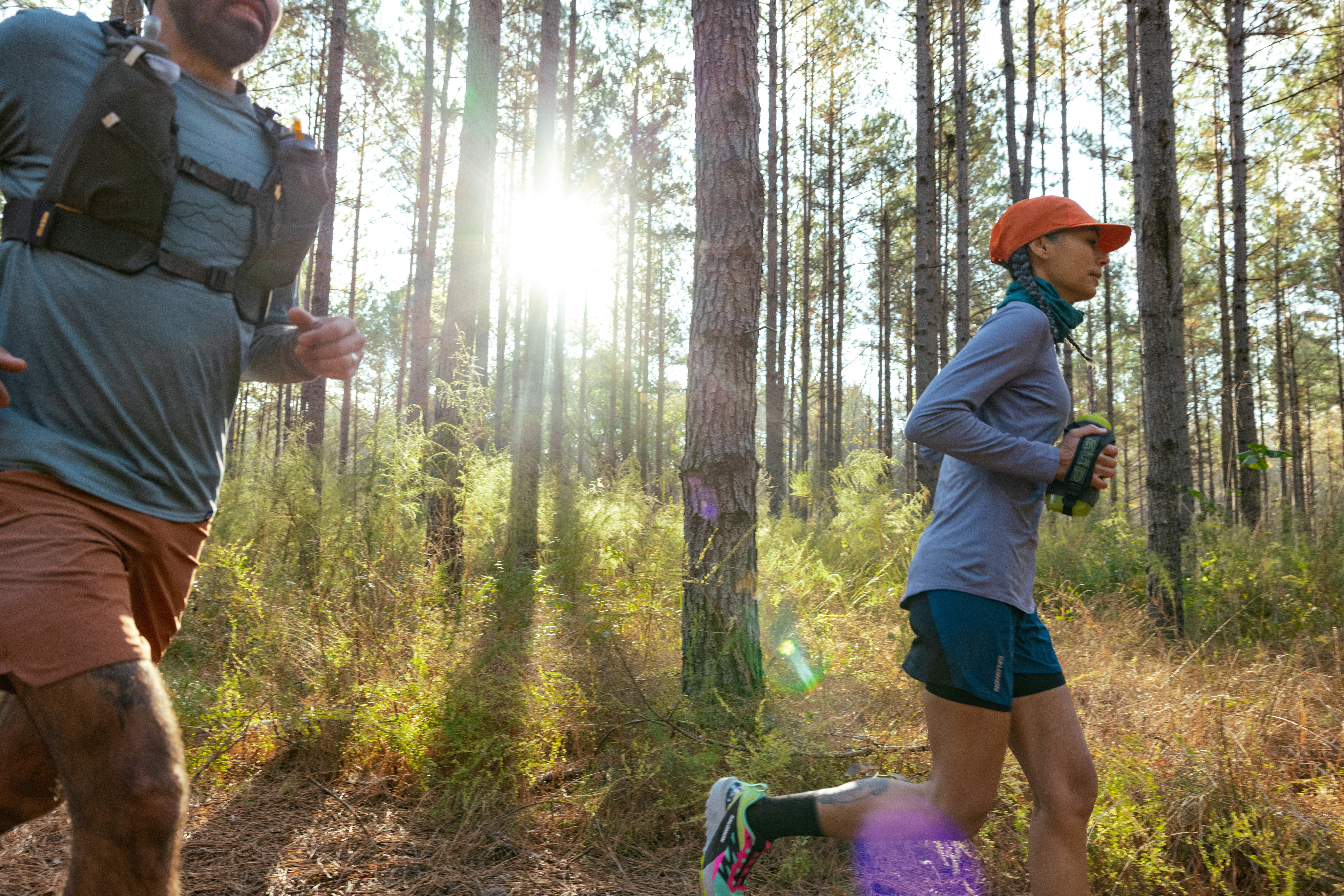 A woman running on a trail in the woods