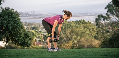 Woman with straight legs and bending forward with flat back