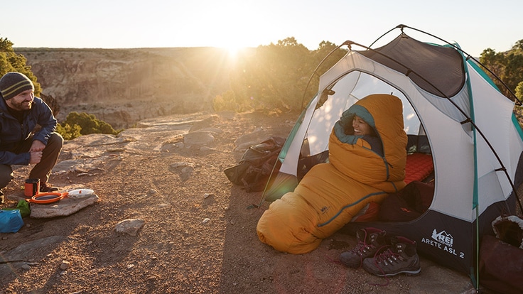 Two people at a campsite in the desert