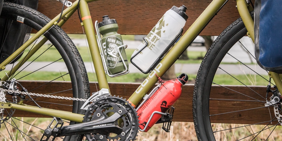 Water bottle cages with water bottles on a bike