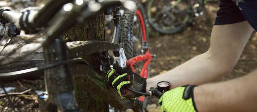 mountain biker adjusting suspension