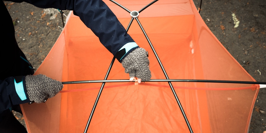 a backpacker pitching their tent