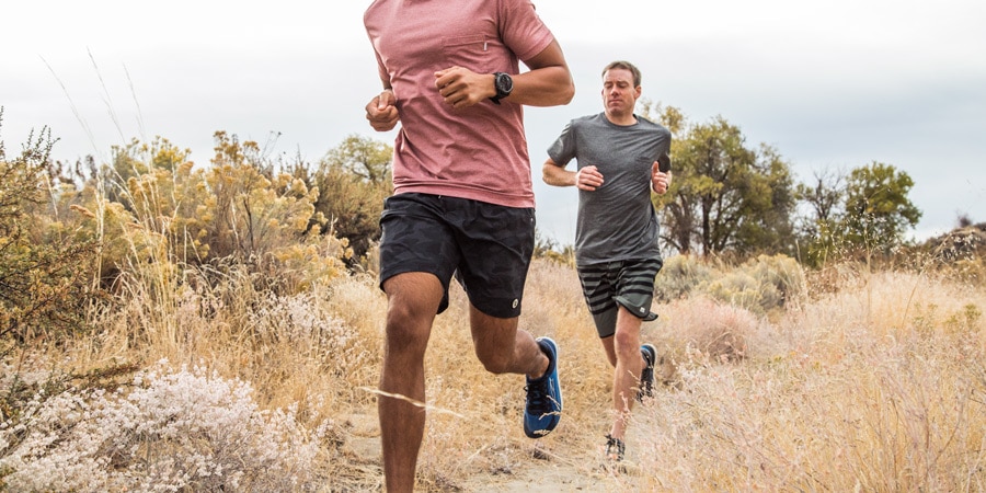 Two men running on a trail