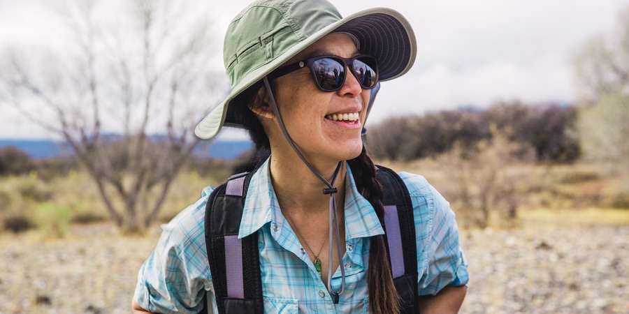 a traveler wearing a sun hat and upf-rated top for sun protection