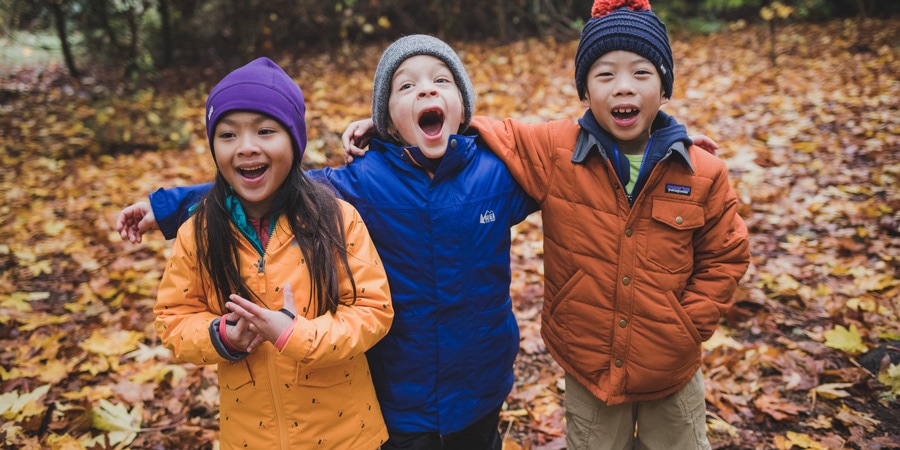 three happy kids hanging out outside