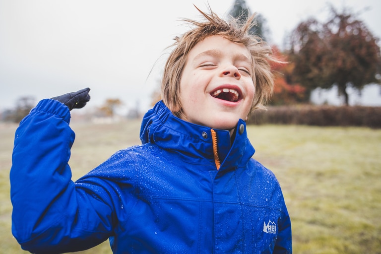 A young kid smiles.