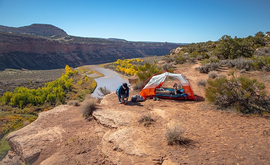 A camper sits in the Big Agnes Copper Spur HV UL Bikepack Tent.