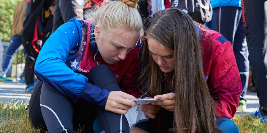 two orienteers looking at an orienteering map