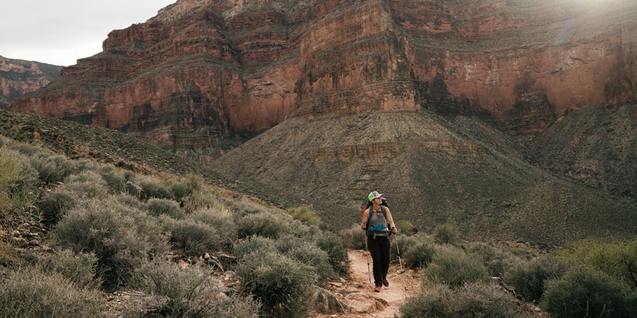 A solo backpacker on a trail in the Grand Canyon