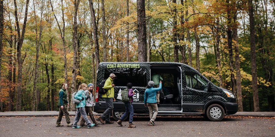 a family boarding a guided tour vehicle