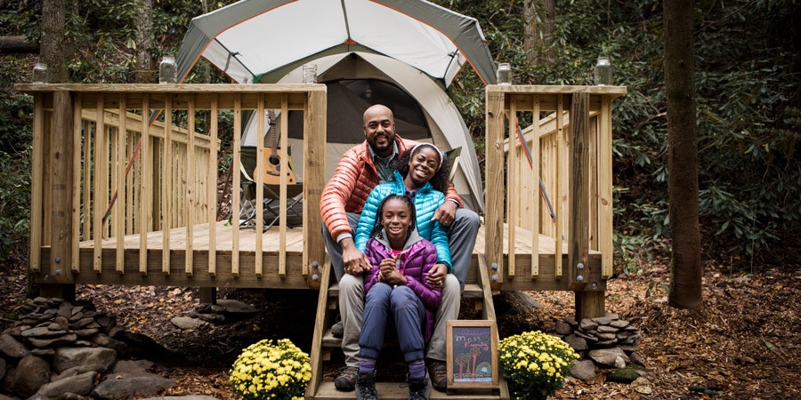 family of three outside their glamping accommodations