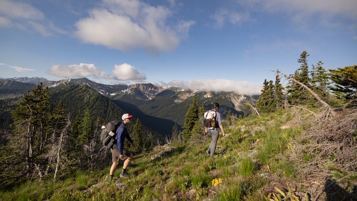 Two people hiking in a mountain landscape