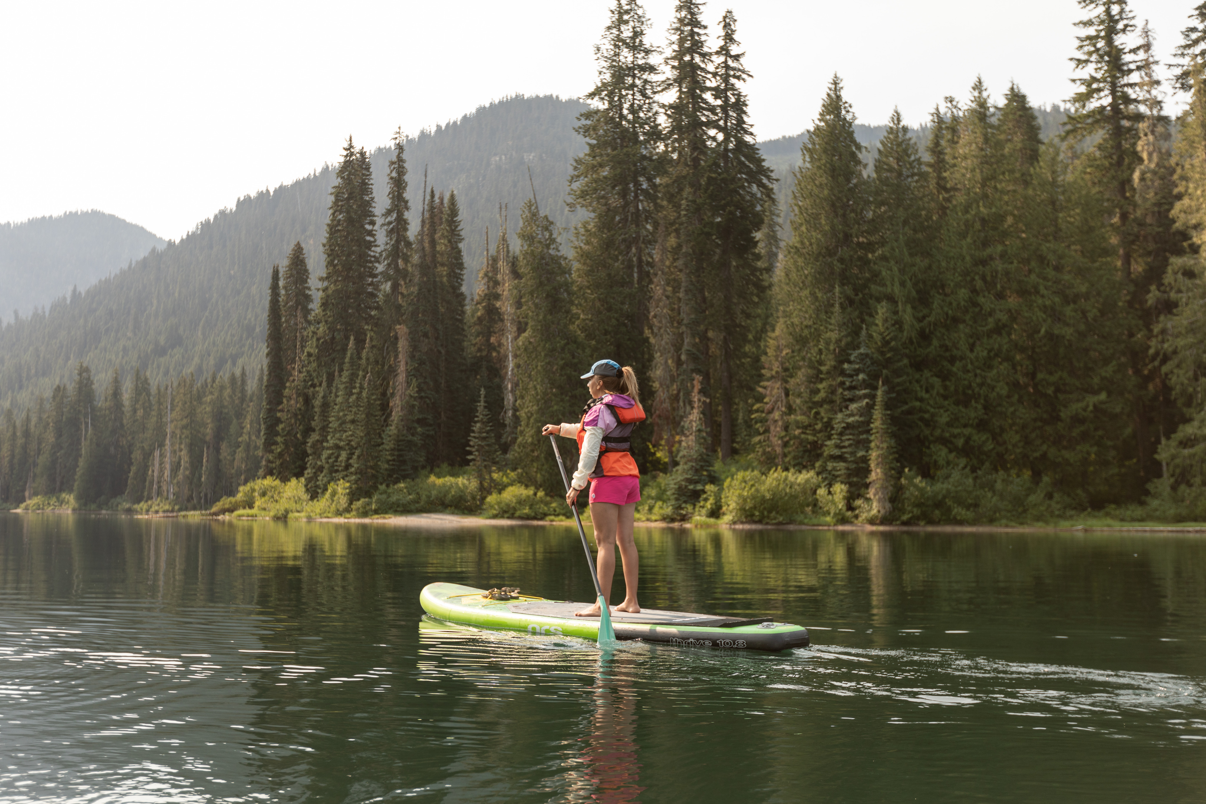 A woman paddling on a stand up paddle board