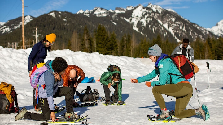 People putting on snowshoes