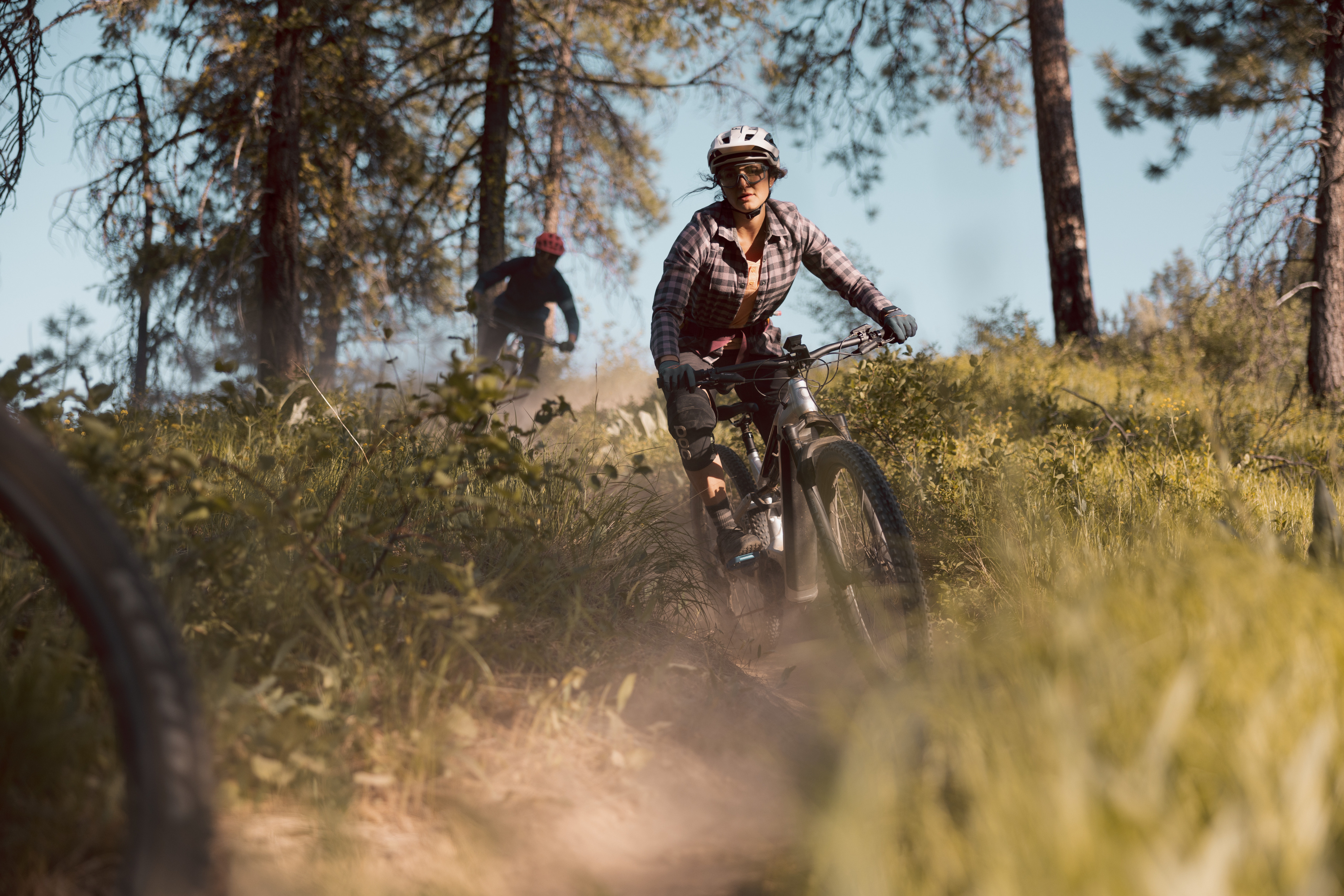 Mountain bikers navigate a dusty trail