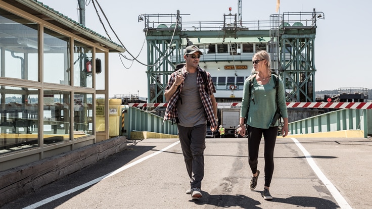 Two travelers walking off a ferry