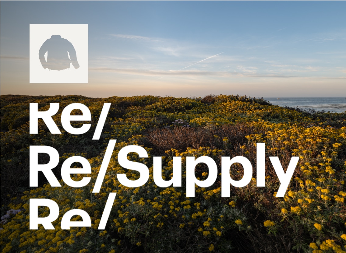 The R E I Re Supply logo over a field of yellow wildflowers.