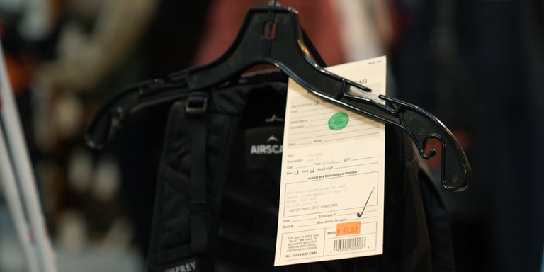 An item of pre-owned outdoor clothing with a Re/Supply tag