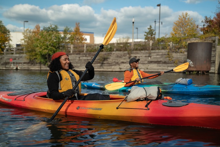 two kayakers enjoying a float down a river