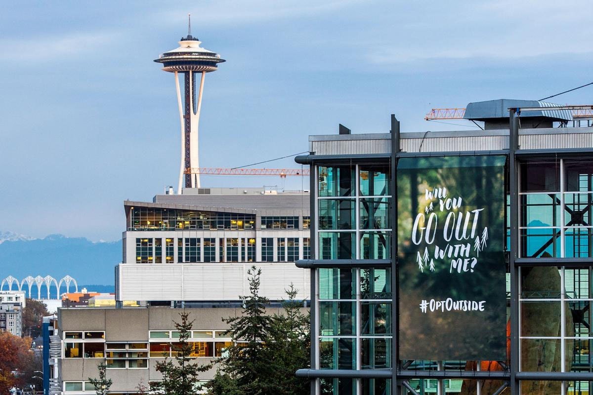 #optoutside banner on the Seattle flagship store with the Space Needle in the background.