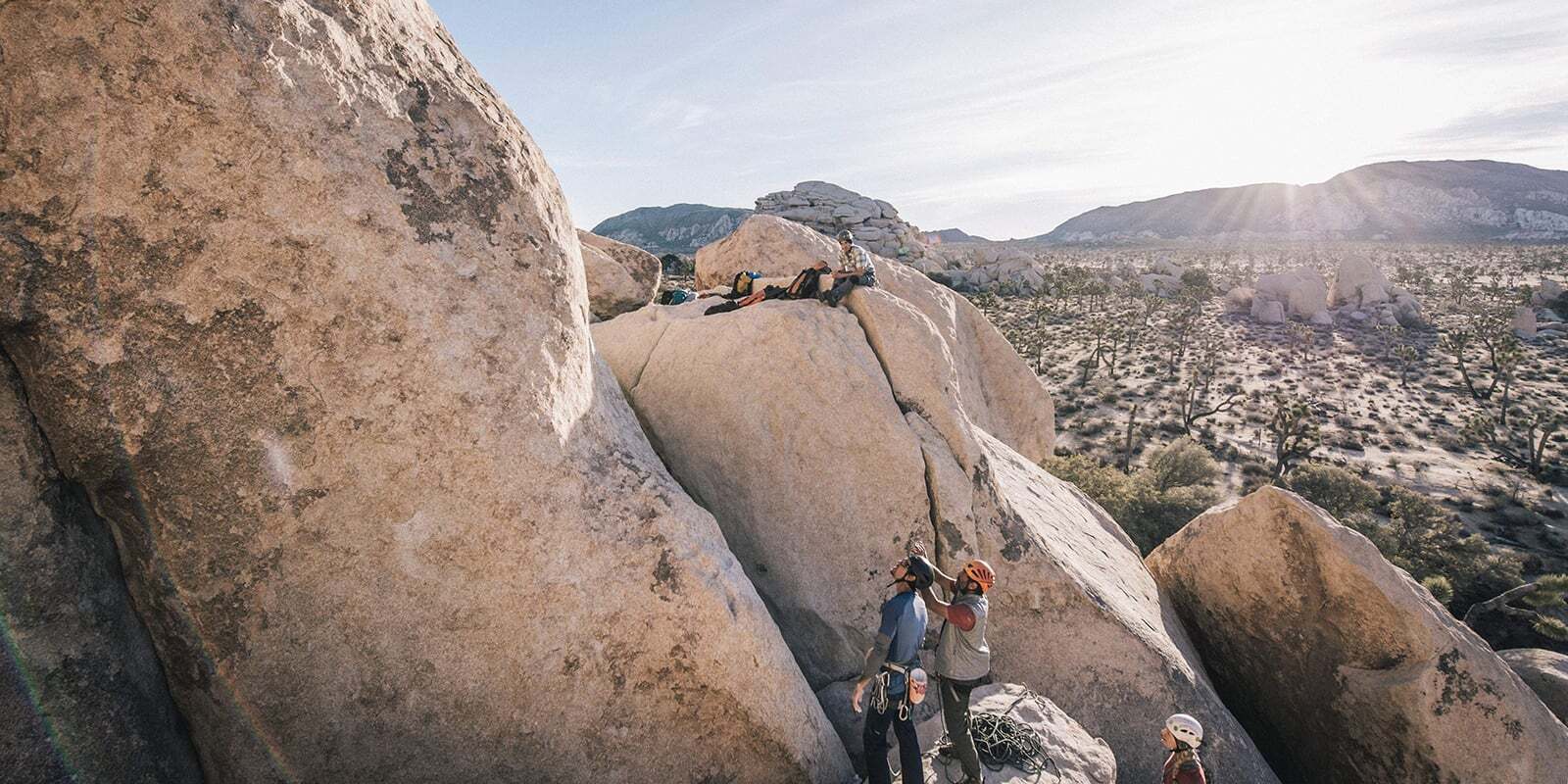 Group stares up at rock deciding on an approach