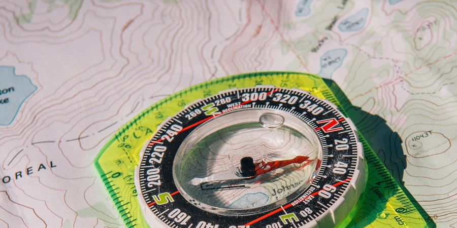 A compass sits on a topographic map