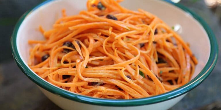 Photo of shaved carrots in a bowl.