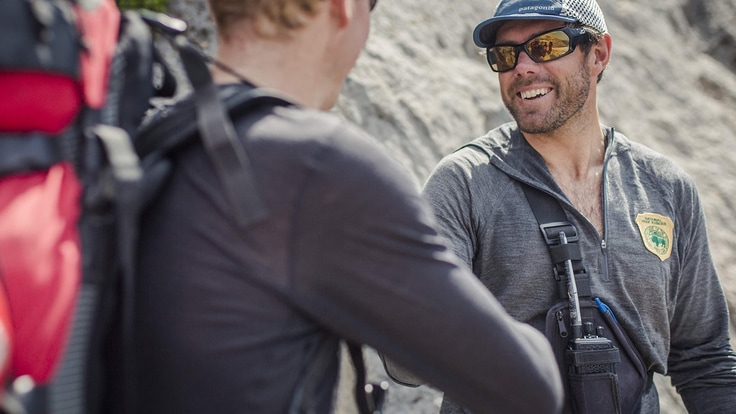 Picture of man with a two-way radio strapped to his chest