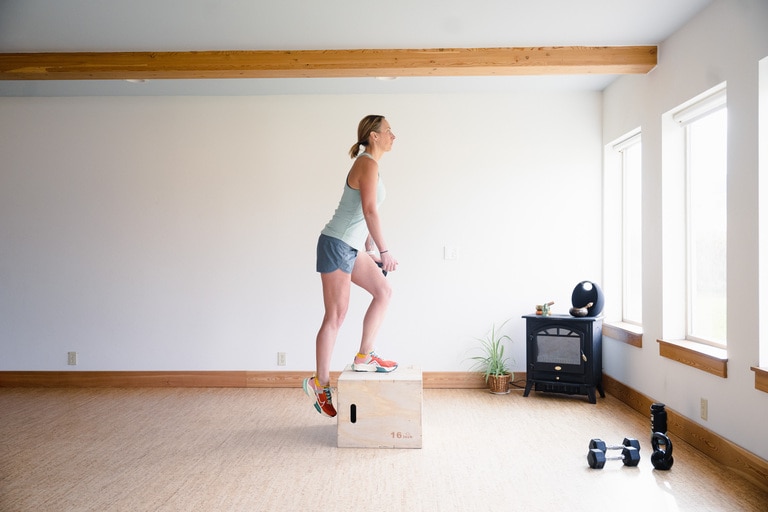 A woman performs a single-leg step up onto a 16-inch box