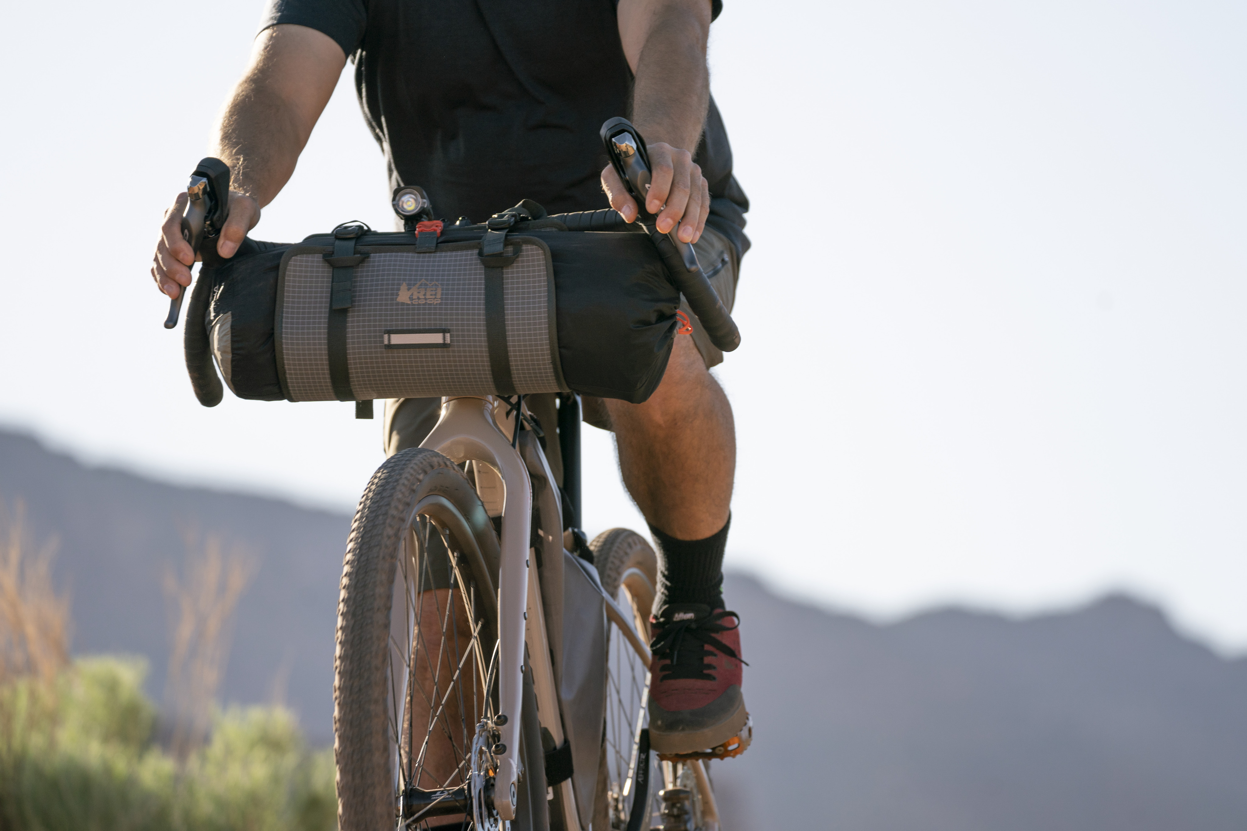 Cyclist on his bike which has a large storage pack