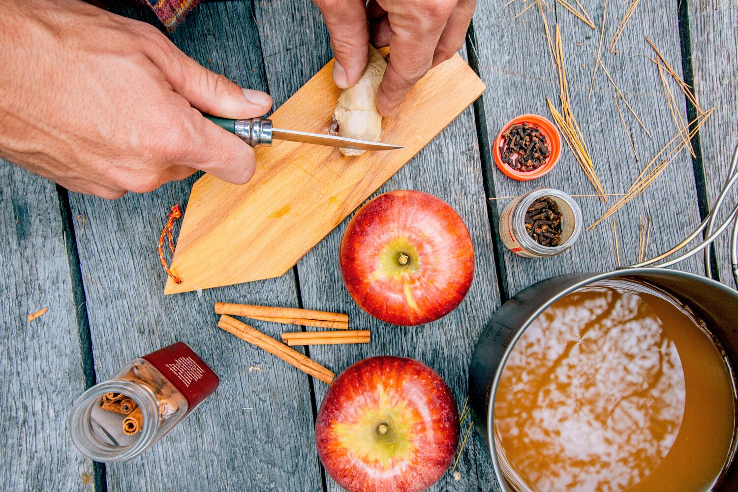 preparing Hot Apple Ginger Cider on a picnic table