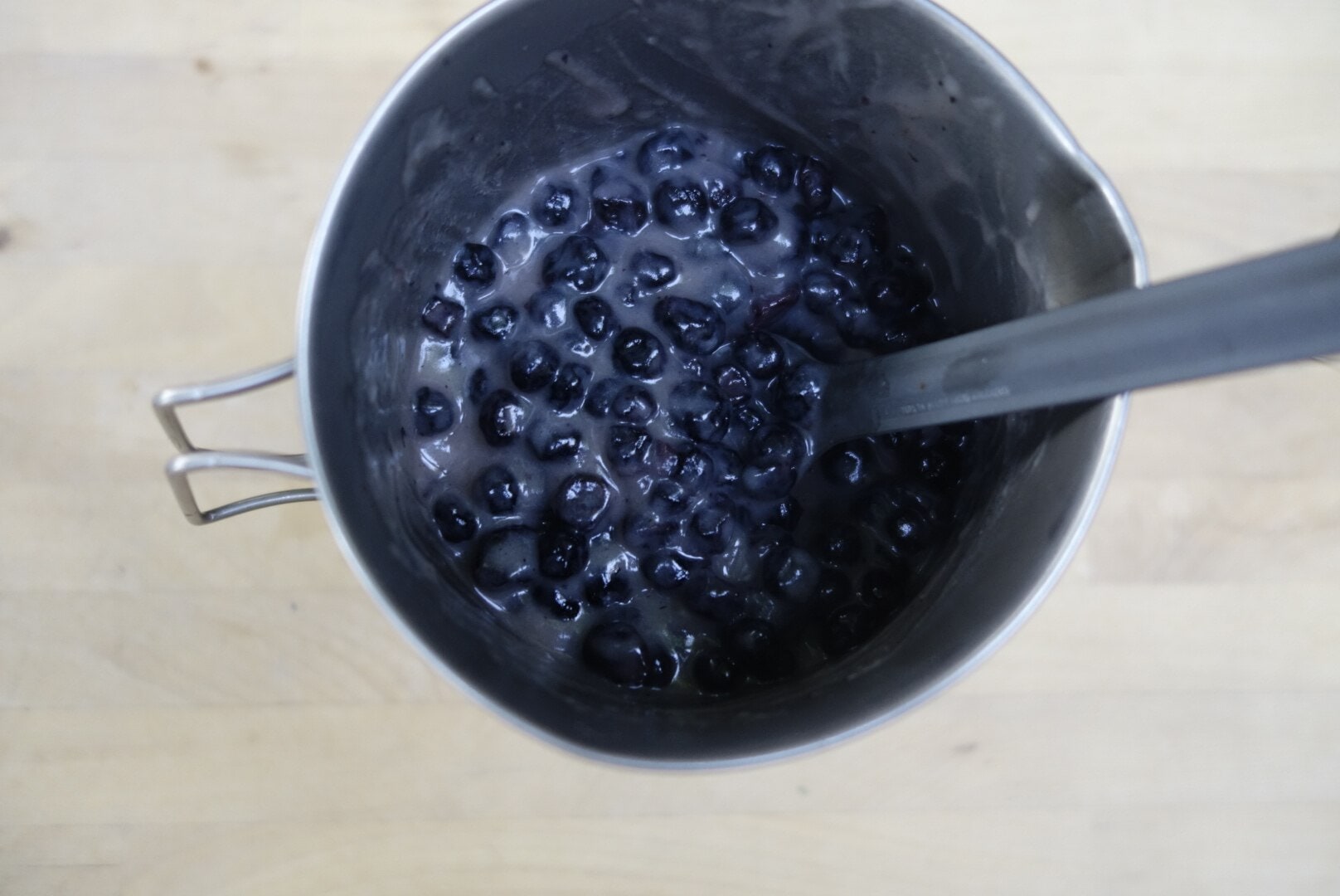 blueberries and spoon in a mug