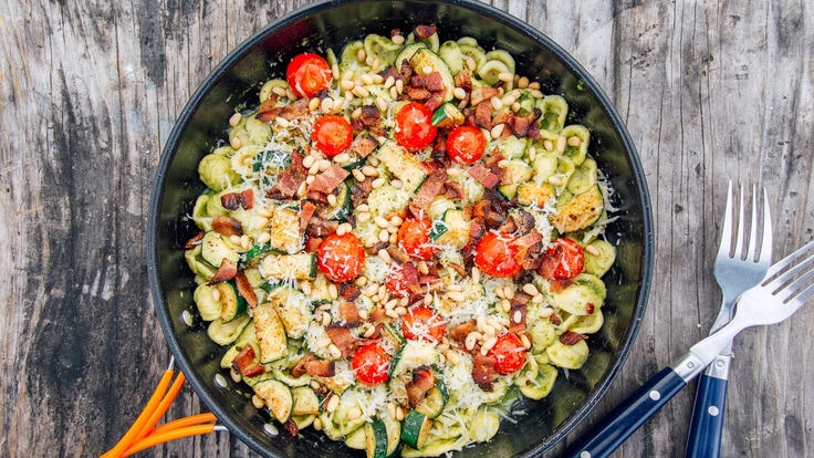 Skillet full of pesto pasta