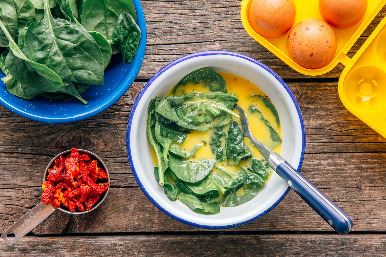 Mixing eggs for spinach frittata