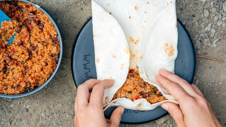 Backpacking burrito bowl being wrapped in tortilla