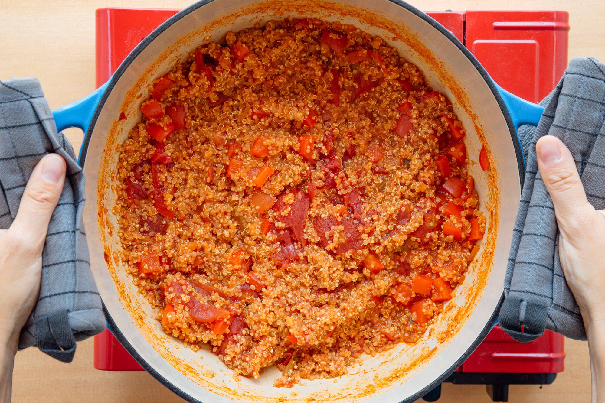 Backpacking burrito bowl quinoa and tomato simmering in pot