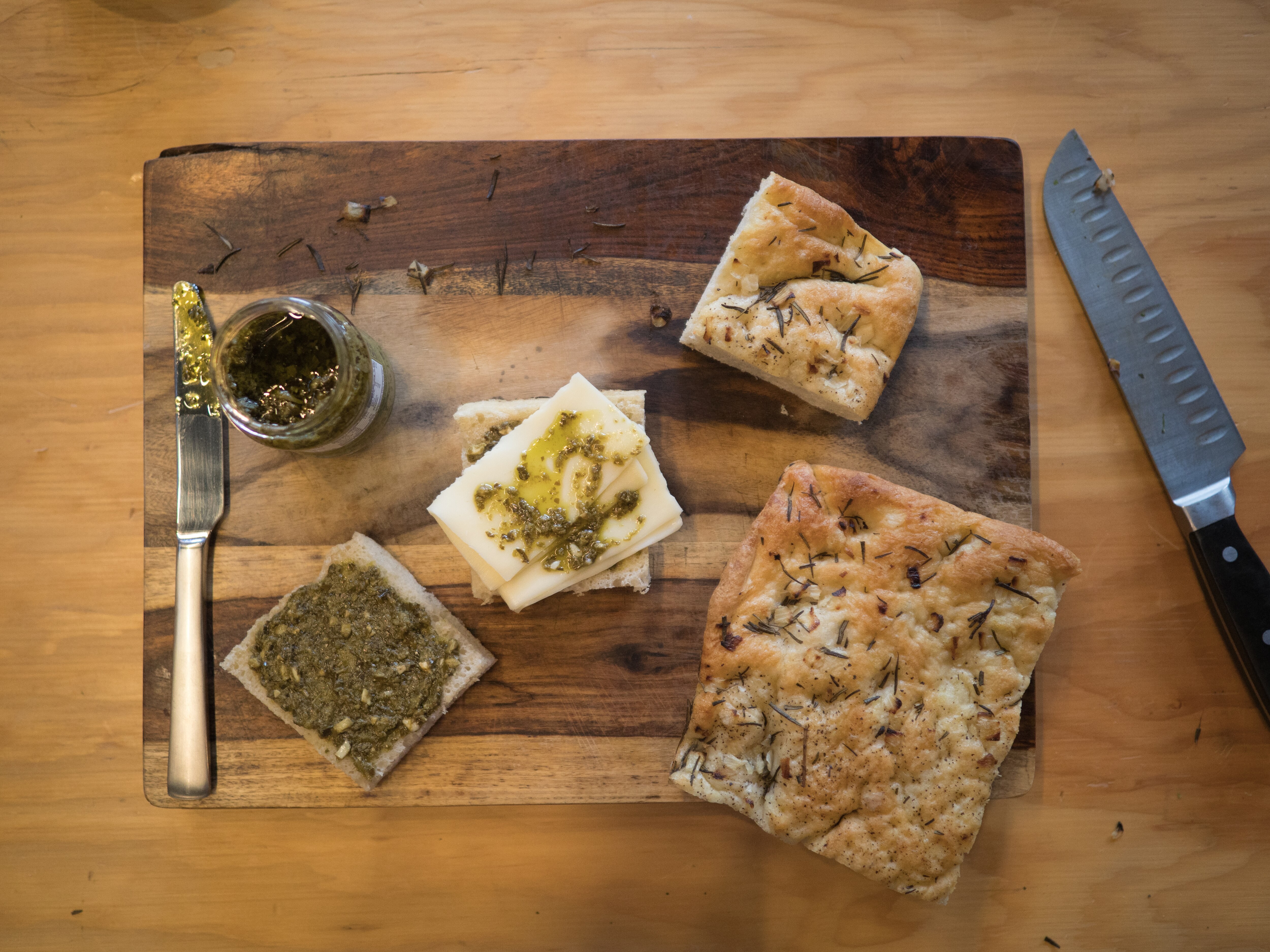 Cheese sandwich makings spread out on a wood cutting board.