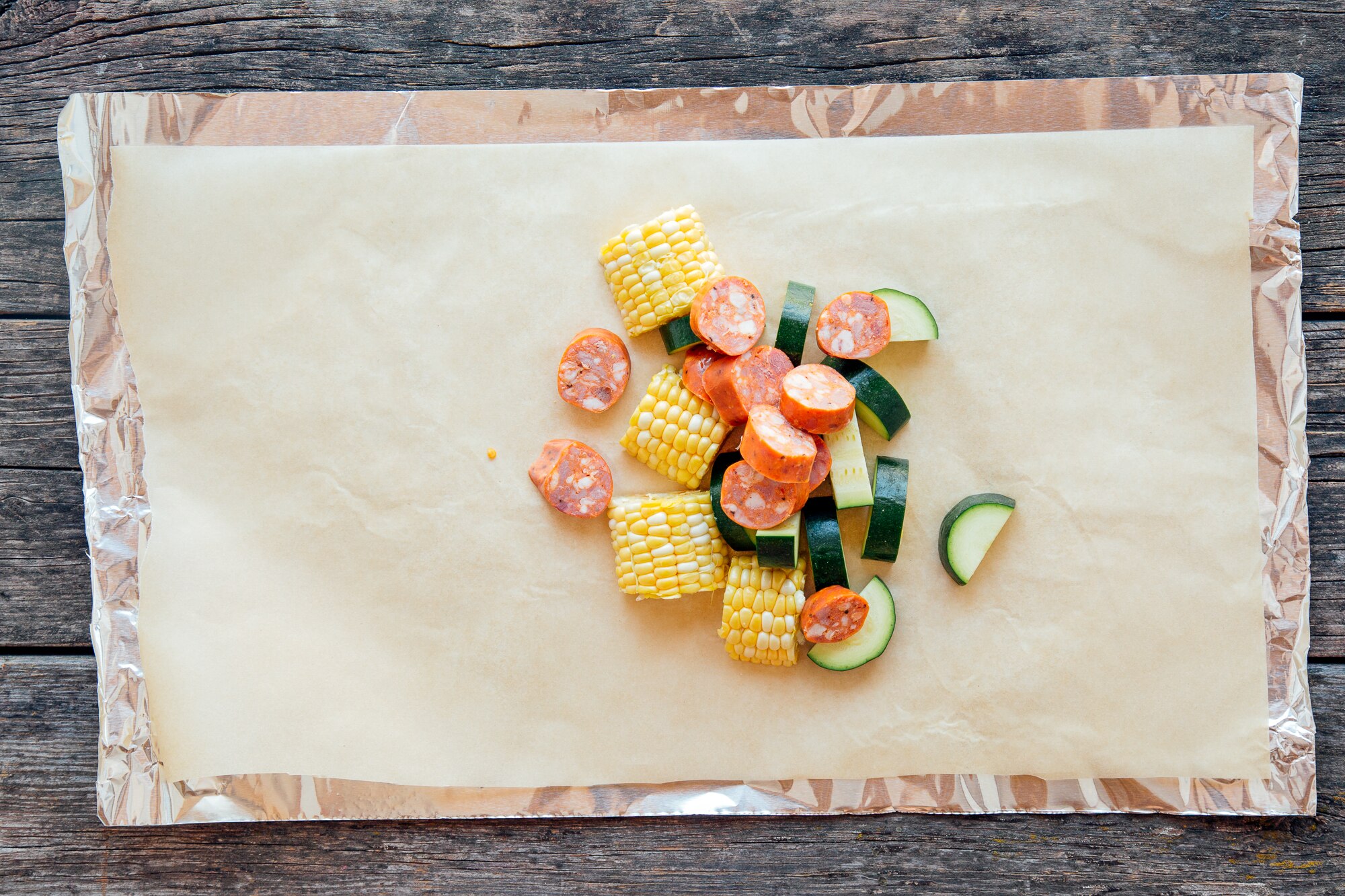 shrimp boil foil packet with corn, zucchini, sausage, and shrimp