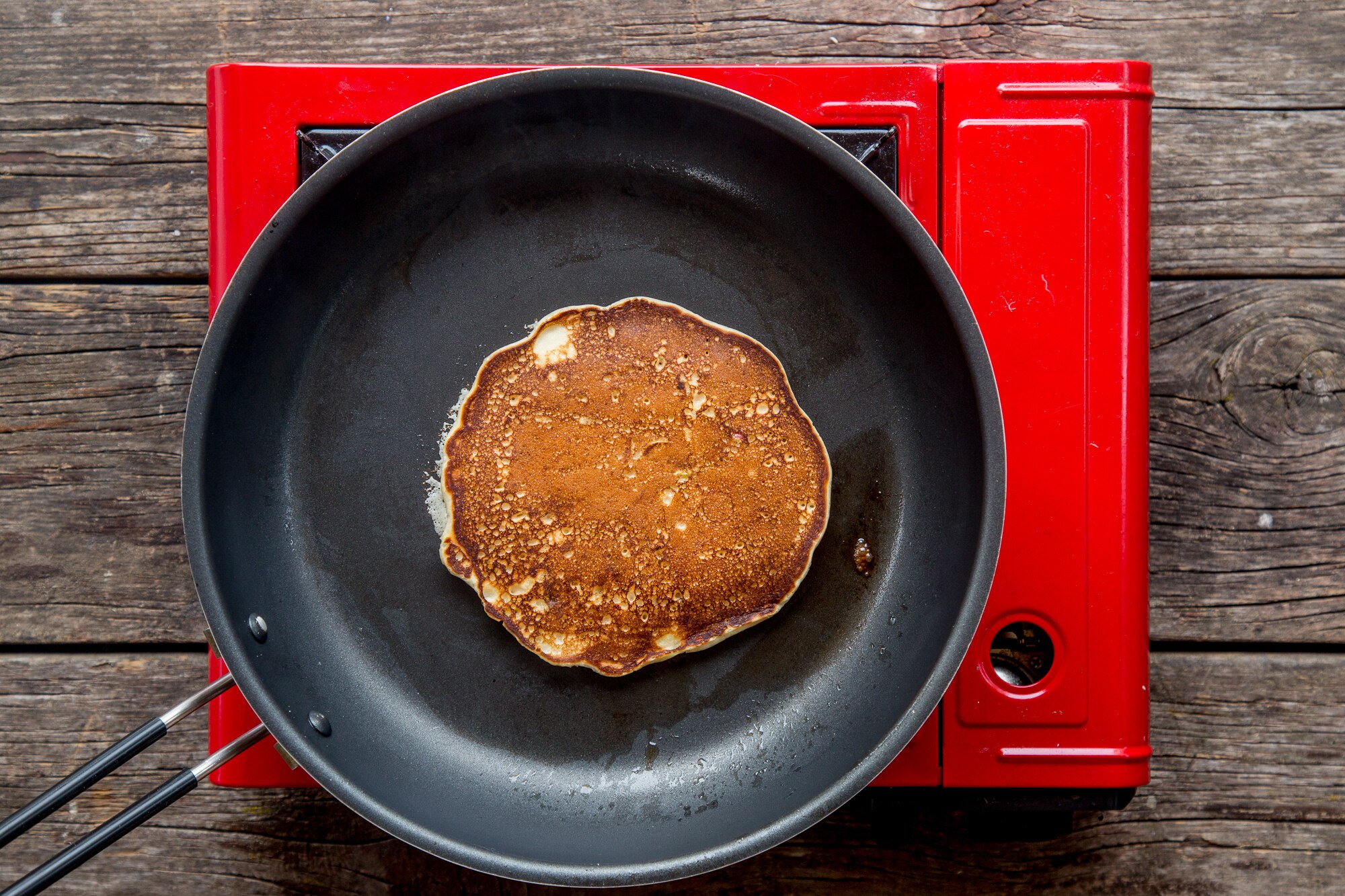 Apple pancake cooking on griddle