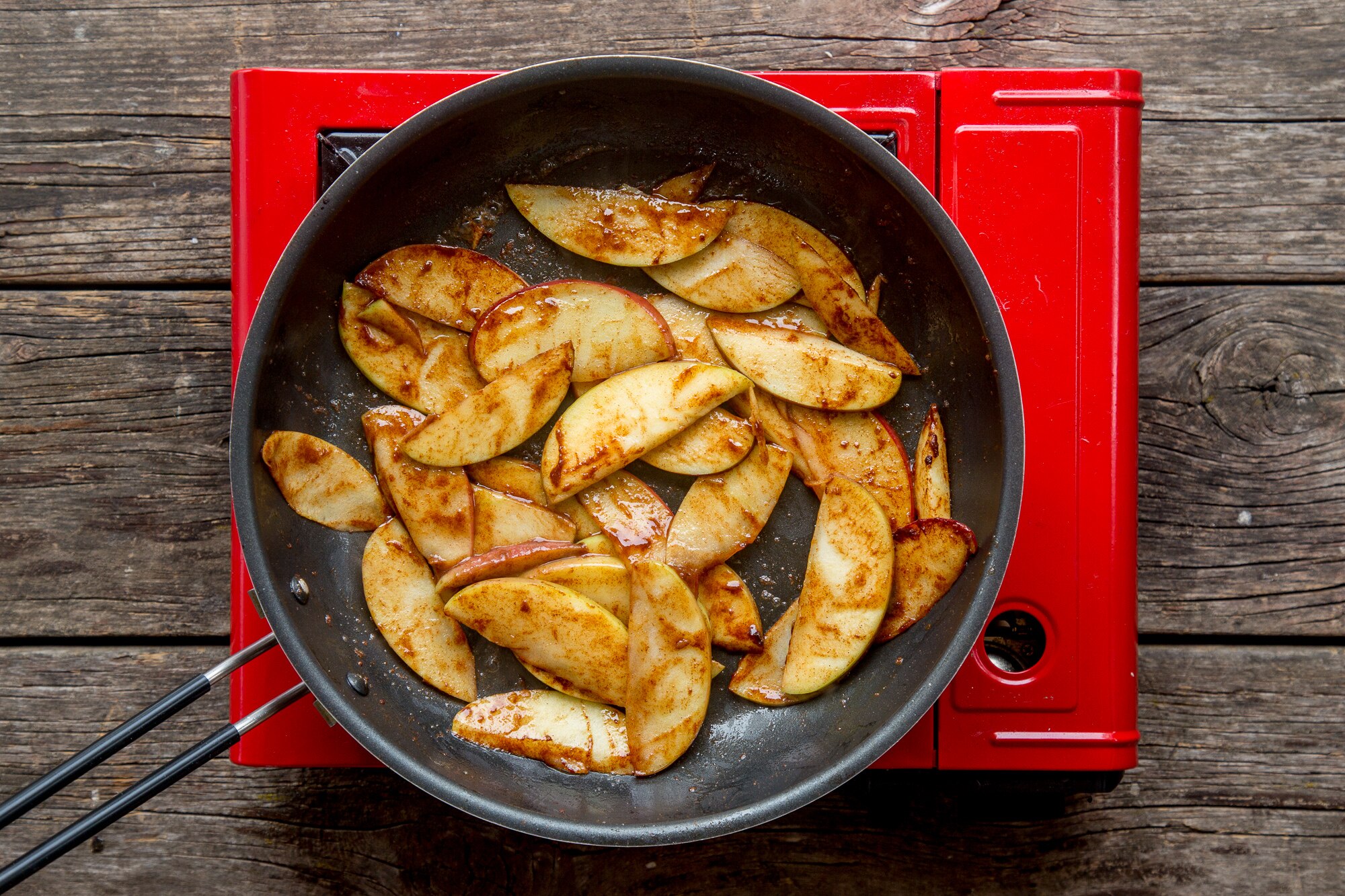 Cinnamon apples in saute pan for topping on apple pancakes