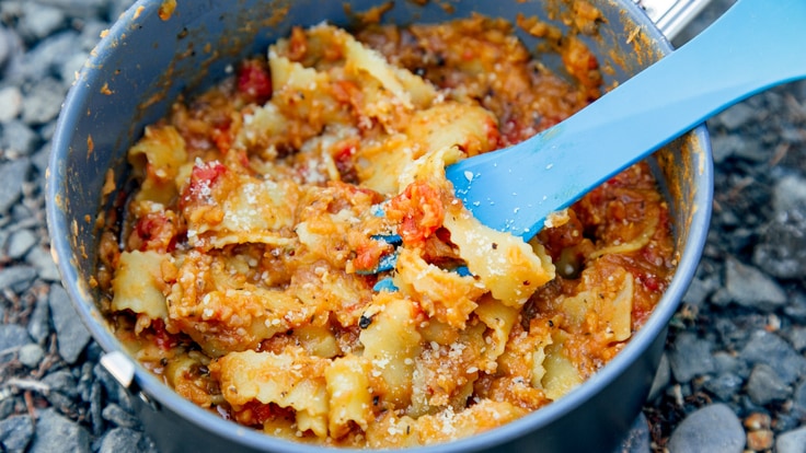 Red lentil marinara sauce and pasta noodles in pan