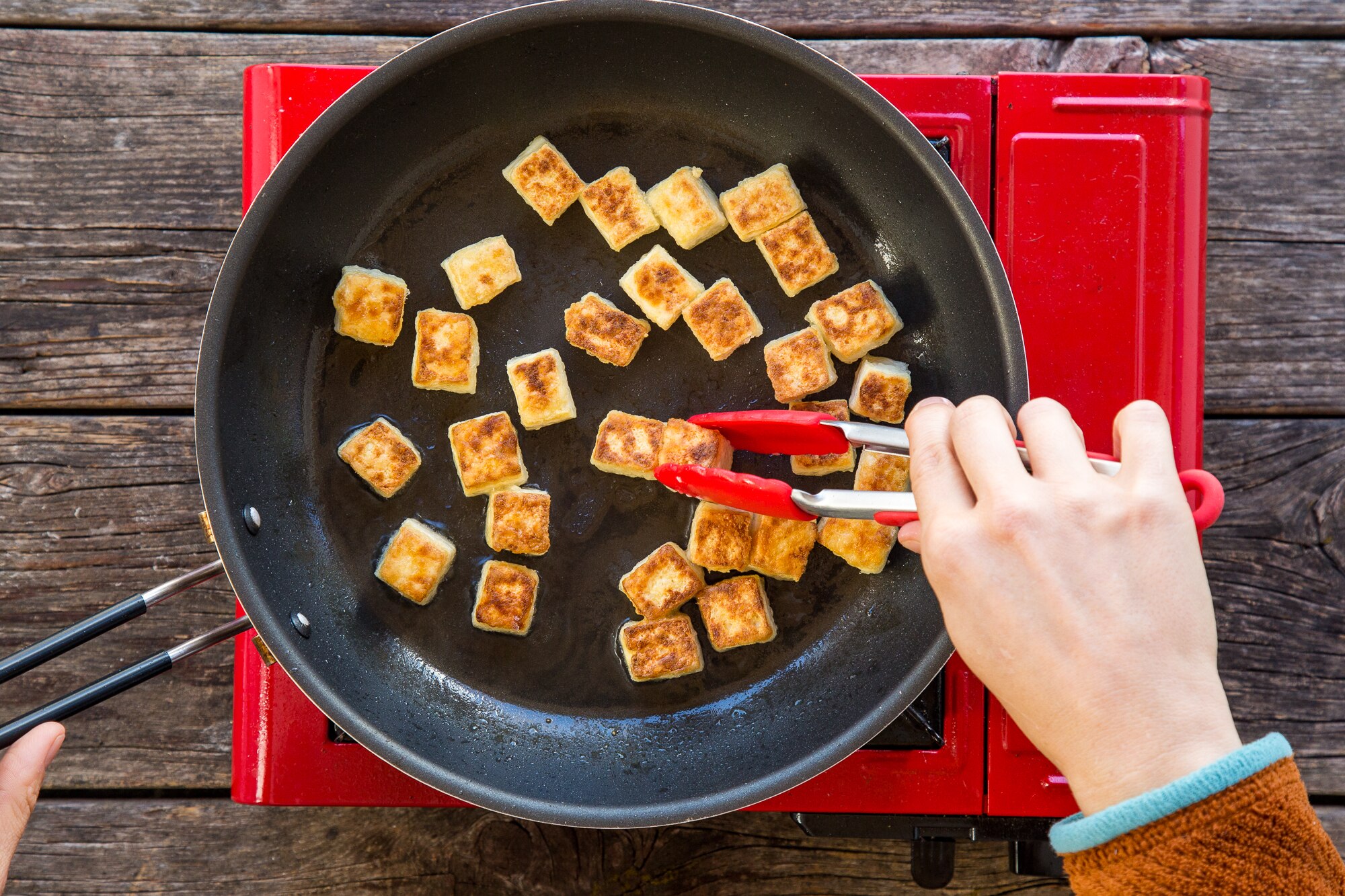 Tofu for green curry cooking in skillet