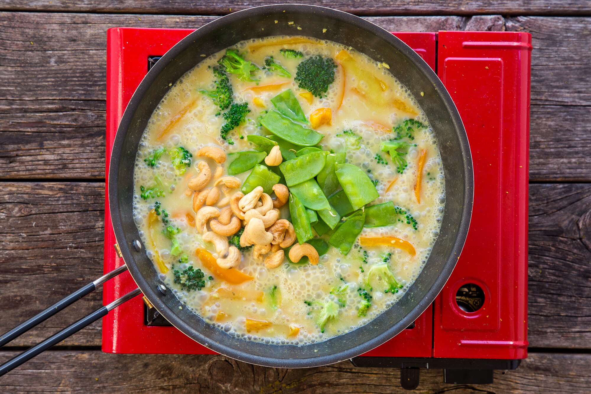 Green curry sauce cooking in pan